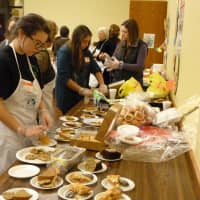 <p>Volunteers prepare to serve pie to diners at Grace Community Center in White Plains.</p>
