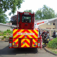 <p>Norwalk firefighters respond to a structure fire at the Ledgebrook Condominium Complex on Gillie&#x27;s Lane Sunday.</p>