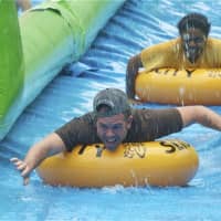 <p>People ride tubes on the slide. </p>
