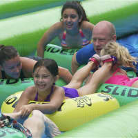 <p>Riders of all ages fill the slide. </p>