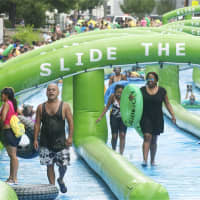 <p>Big crowds turn out to Slide the City on Sunday in Stamford.</p>
