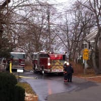 <p>Firefighters pick up Sunday morning after extinguishing a fire on Washington Avenue in Westport. </p>