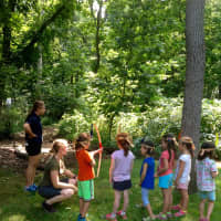 <p>Weinberg Nature Center staff show campers how to use a bow and arrow, placing stuffed animals such as bobcat, beaver, deer, rabbit and bear in the woods for them to &quot;hunt.&quot;</p>