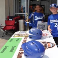 <p>Norwalk Cal Ripken 11-year-old All-Stars Jayden Gonzalez and Jake Palmer man the table outside Sports Authority.</p>