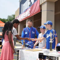 <p>Players Michael Berkowitz and Kyle Root work at a table at Lowe&#x27;s along with store manager Angelo Resso and assistant store manager Dan Nieves.</p>