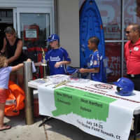 <p>Jayden Gonzalez and Jake Palmer man the table outside Sports Authority along with co-manager Barry Jones.</p>