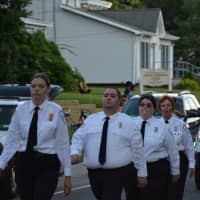 <p>Carmel Volunteer Ambulance Corps members march in the Brewster parade.</p>