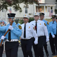 <p>Putnam Valley firefighters march in the Brewster parade.</p>