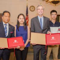 <p>White Plains Mayor Thomas Roach and White Plains Safety Commissioner David Chong received gifts from Chenglin Zhang (second from left) and Chang Liu (right) who represent the student delegation from Guizhou Province in China.</p>