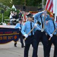 <p>Pound Ridge firefighters march in the Bedford Village parade.</p>