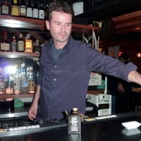<p>David Gorrie, bar manager at the Pink Sumo, pours a customer a glass of water at the bar Tuesday afternoon. </p>