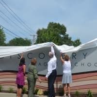 <p>Bridgeport Mayor Bill Finch and other officials unveil the new signs at Discovery Interdistrict Magnet School.</p>