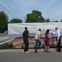 <p>Officials get ready to reveal the new sign. </p>