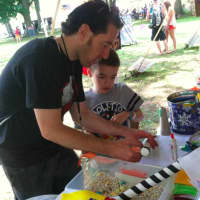 <p>Josh Hurd and his son Kyle at the Kids Corner at Gathering of the Vibes.</p>