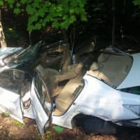 <p>Firefighters cut away the roof of the car to rescue the driver. </p>