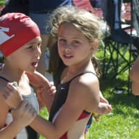 <p>Two friends get each other ready to compete Sunday morning at Briarcliff.</p>
