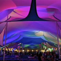 <p>Inside the colorful VIP tent at Gathering of the Vibes.</p>