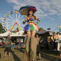 <p>A girl on stilts roams the crowd at Seaside Park.</p>