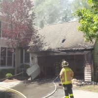 <p>A Mount Kisco firefighter responds to a blaze at the Riverwoods condo complex in New Castle.</p>