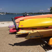 <p>The kayaks are stacked up and ready to go at the Long Island Sound beach.</p>