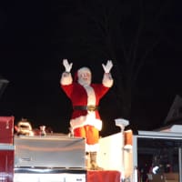 <p>Santa Claus arrives outside Christ &amp; Holy Trinity Church in Westport aboard a fire truck Thursday night.</p>