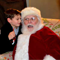 <p>A child tells Santa what he wants for Christmas at Christ &amp; Holy Trinity Church in Westport during Thursday&#x27;s holiday gathering.</p>