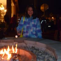 <p>Rebecca Serven, 12, of New Canaan, combined winter with summer as she roasted a marshmallow over the new fire pit to cook up a Christmas S&#x27;more.</p>