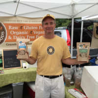 <p>John Schulz, owner of Pound Ridge, N.Y.-based Healing Home Foods, poses in front of his tent Thursday at the Westport Farmers Market.</p>