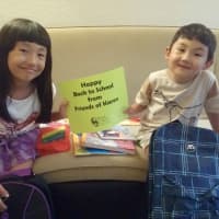 <p>Ayanat and Ayat enjoying their school supplies.</p>