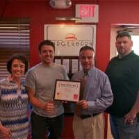 <p>Daily Voice Director of Media Initiatives/Managing Editor Joe Lombardi (second from right) presents DVLicious Best Burger Award to Somers&#x27; Burger Barn (from left): Linda Tesone, Justin Tesone and Paul Sanders.</p>