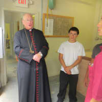 <p>Cardinal Timothy Dolan talks about the Papal project Thursday at Lincoln Hall in Somers with Bill Kelley of Montrose, left, the wood shop teacher, Frank Corazao, 15, of New Rochelle and Mauricio Agudero,  17, of Ossining, student carpenters.</p>