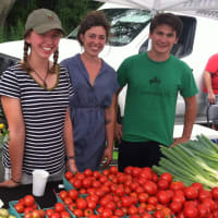 <p>Alexis Barbalinardo, center, farm manager at Back 40 Farm, of Washington, CT., with interns Katie Carlson and Fred Baker at the Old Greenwich Farmers Market.</p>