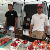 <p>Louis Ethier, left, and Jesse Teveris, right, employees of Woodland Farm of South Glastonbury, at the Old Greenwich Farmers Market.</p>