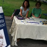 <p>Nancy Henkes, left, and Allison Lowrie, right, offering prayer services at the Old Greenwich Farmers Market.</p>