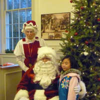 <p>Laura Chen, 6, visits with Santa and Mrs. Claus at the Somers Town House.</p>