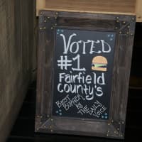 <p>Bogey&#x27;s Grille &amp; Tap Room touts its DVlicious win on a chalkboard on the way to the dining room.</p>
