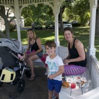 <p>From left: Shannon Keefe, Lucas Dawkins, 4, and Sarah Dawkins enjoy lunch on the waterfront near the farmers market.</p>