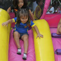 <p>A girl takes a ride down the slide at Sunday&#x27;s Ecuadorian Festival.</p>