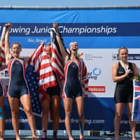 <p>Kaitlyn Kynast, partially obscured by her flag, celebrates with teammates.</p>
