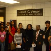<p>Members of the Paige family unveil the Jason C. Paige Fitness Center Tuesday. </p>