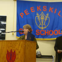 <p>Peekskill Mayor Mary Foster presents a proclamation from the city honoring Jason Paige.</p>