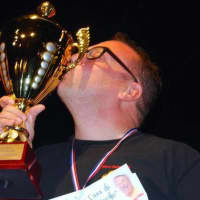 <p>Bruno di Fabio kisses his trophy after winning the Pizza World Championship in Paris.</p>