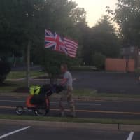 <p>Neil Davis is flying the British and American flags from his car. </p>