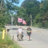 <p>Neil Davis, right, making his way through Southeast, on Route 6, late Thursday morning.</p>