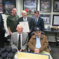 <p>New Rochelle Mayor Noam Bramson (top right) presents a proclamation for Steiner Sports Memorabillia Day to CEO Brandon Steiner at company headquarters Wednesday. David Cone (top left) Don Larsen (front left) and Yogi Berra (right) join in.</p>
