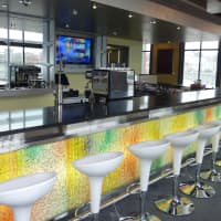 <p>The colorful bar at Moja, a South American-Asian fusion restaurant opening Saturday, will be the first thing guests see when they walk into the restaurant. </p>