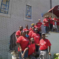 <p>Volunteers who helped re-paint the Allen Temple AME Church pose for a photo in front of the church.</p>