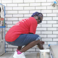 <p>Volunteers paint the exterior of the Allen Temple AME Church in Mount Vernon. </p>