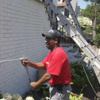 <p>Pastor Hugh Marriott works on painting the church Friday in Mount Vernon. </p>