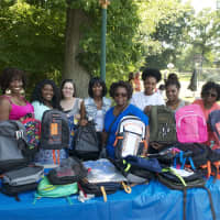 <p>Volunteers gather Saturday for a Family Day and to hand out backpacks. </p>